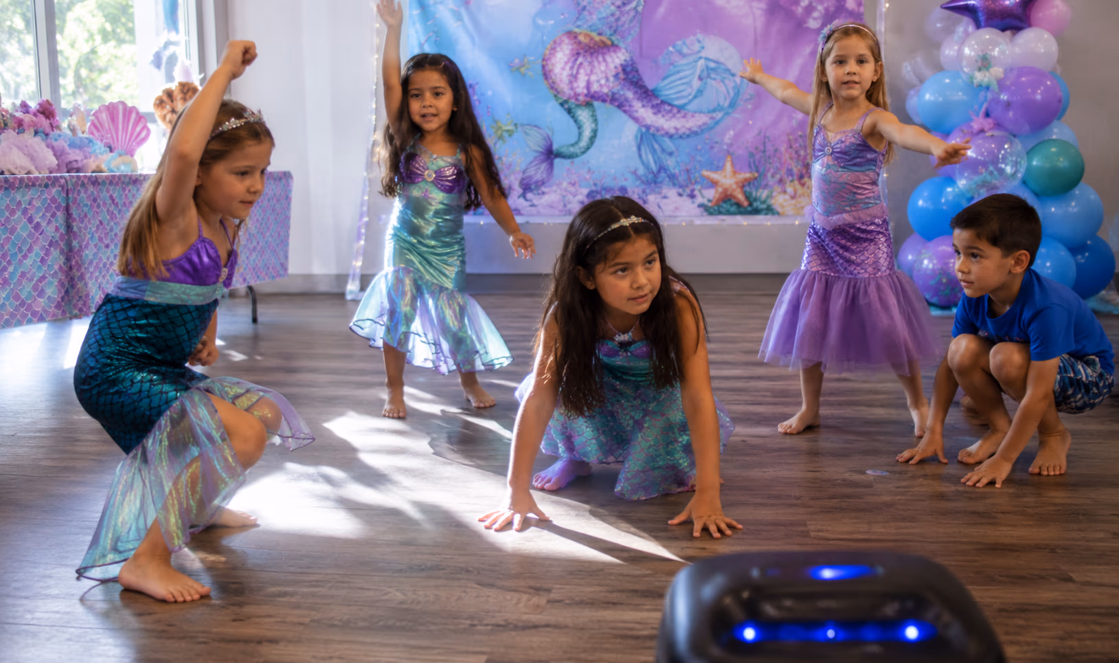 Mermaid freeze dance game setup with ocean music and open dance space